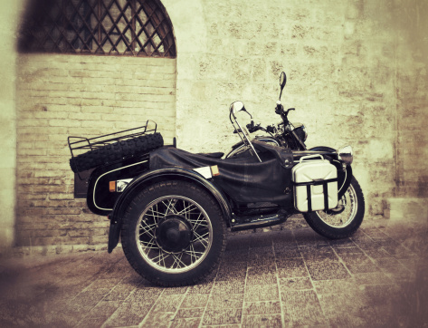 Vintage motorcycle with sidecar. Added texture, damage, age effect.\u2028http://www.massimomerlini.it/is/transportation.jpg
