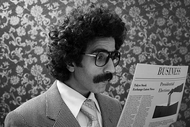 Businessman with big hair reading newspaper