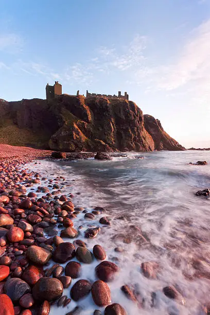 Dunnottar Bay just after sunrise.  The ruined castle can be seen on the clifftop.