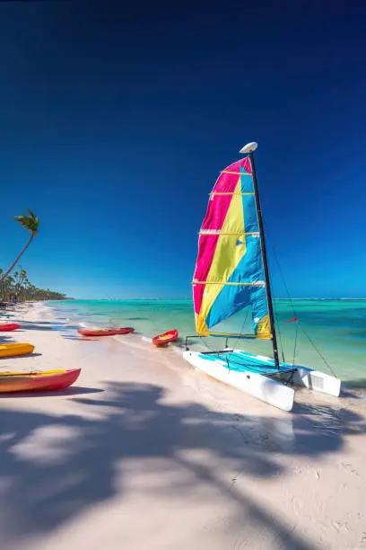 Colorful catamaran sailboat on tropical beach