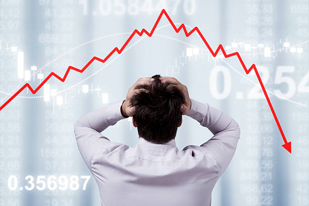 Businessman Businessman standing in front of the panel with financial statistics  stock market crash photos stock pictures, royalty-free photos & images