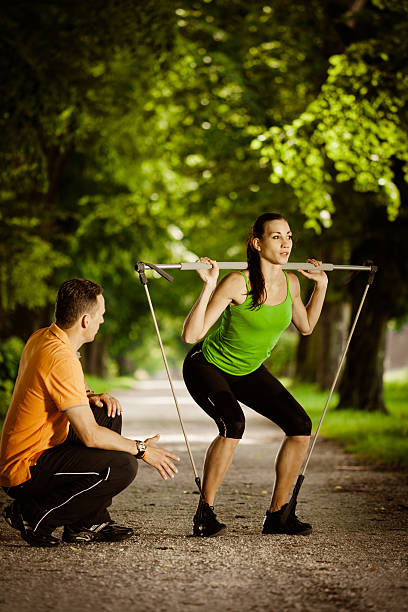 istock Trainer Giving Advice To His Young Female Athlete 155351415