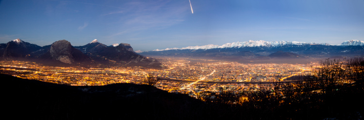 Aerial view of the city of Grenoble with the french Alps and its eternal snow glacier  in the backgrounds