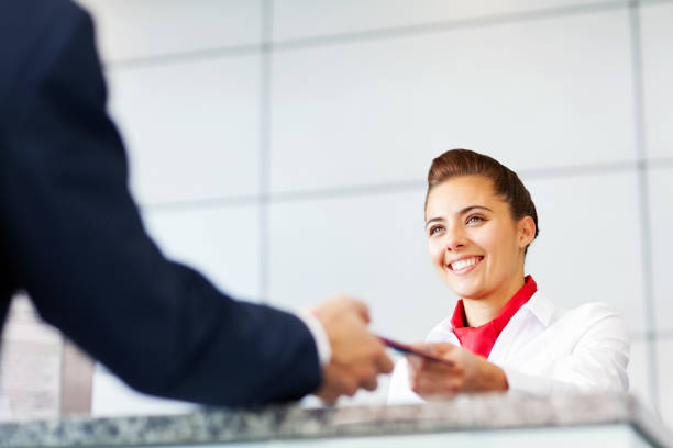 istock Airline Check In Attendant Handing Tickets To Passenger 155352597