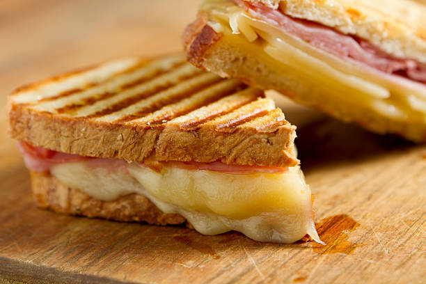 istock Cheese and ham panini sandwiches on a wooden board 155352902