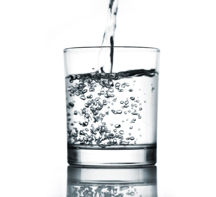 Mineral water being poured into a glass.