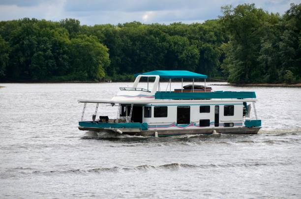 House Boat Floating on Mississippi River The wide Mississippi River with house boat, taken in Minnesota. houseboat photos stock pictures, royalty-free photos & images