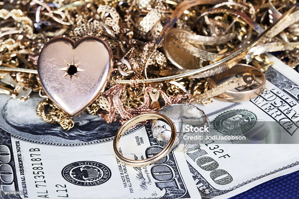 scrap gold wedding rings in a pile of scrap gold being sold to pay for a divorce Divorce Stock Photo