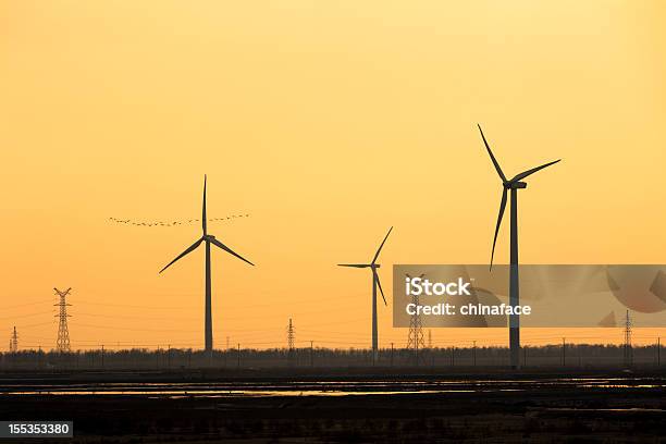 Wind Turbine And Electrical Towers On Sunset Stock Photo - Download Image Now - Cable, Three Dimensional, Cloud - Sky