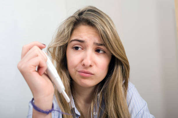 istock Teenager looking at a pregnancy test 155353505