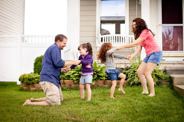 istock Happy Sisters Playing Outside with Mom and Dad in Yard 155353583