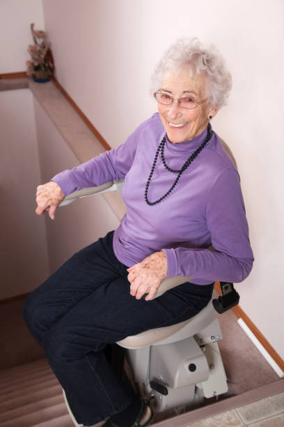 istock Elderly woman using stairlift: assisted living 155354292
