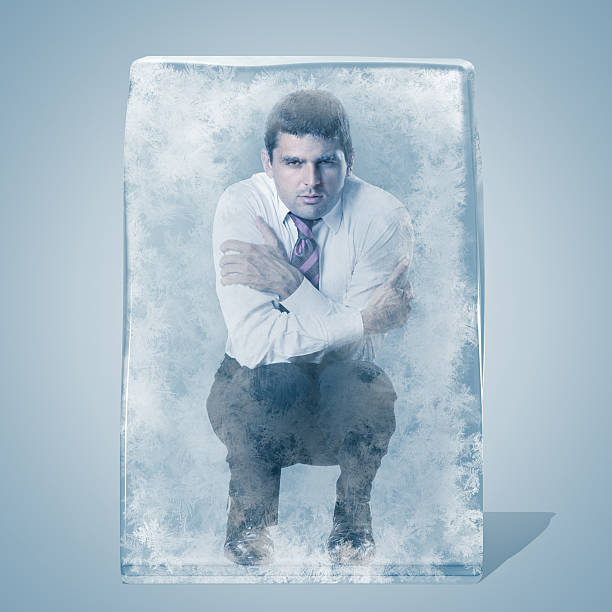 istock Businessman crouched frozen in an ice space 155354323