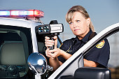 Traffic Enforcement: Woman Police Officer with Laser Gun