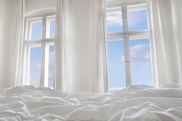 Looking the blue sky through bedroom windows More like this: sunny window stock pictures, royalty-free photos & images