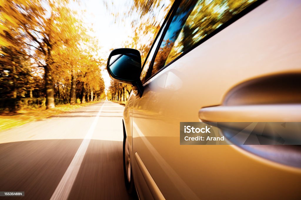 view from side of fast moving car view from side of fast moving car on country autumn road Autumn Stock Photo