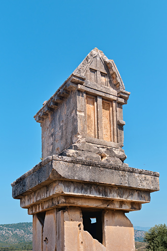 Antalya, Turkey - July 15, 2023: Grave monument and the ruins of ancient city of Xanthos