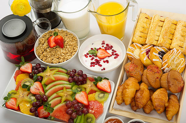 Continental Breakfast Buffet Breakfast buffet with a fruit platter, assorted baked goods, granola, yoghurt,orange juice, milk,coffee and tea continental breakfast stock pictures, royalty-free photos & images