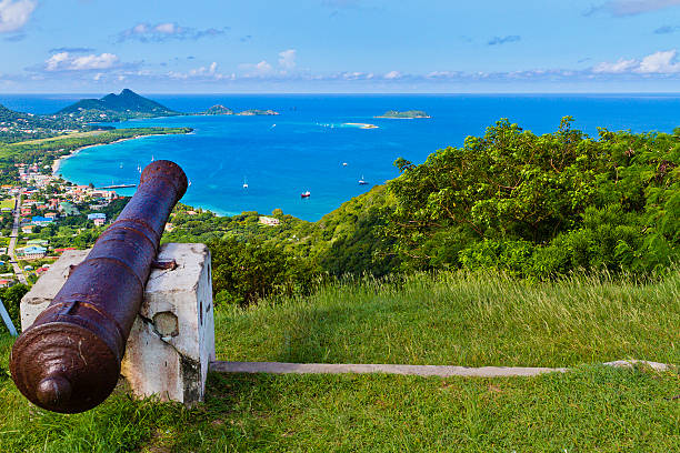 From the hill of Belair, the site of the Carriacou hospital, you can have a breathtaking view of the town of Hillsborough and its beautiful bay. Visible is also the small Sandy Island with its white sandy beach. Some old rusty cannons are pointed on the bay. Carriacou, Grenada W.I.