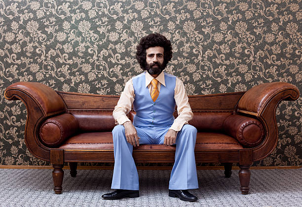 istock Businessman in 1970s style sitting on sofa 155355094