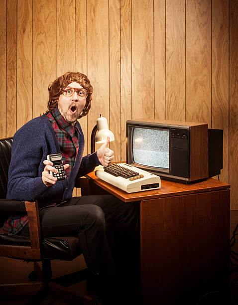 istock surprised haired Geeky Nerd Man with vintgae computer and calculator 155355242