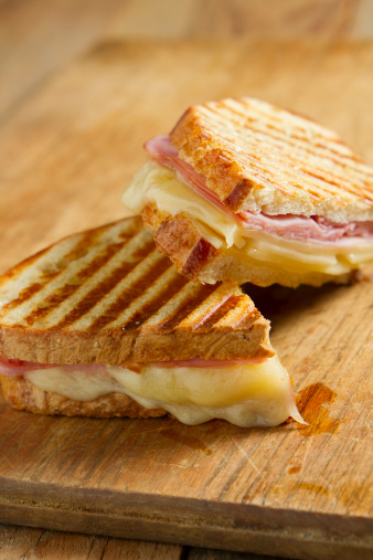 Hot off the grill panini sandwiches made with crusty, hand sliced bread, black forest ham and swiss cheese.
