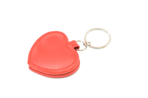 Red leather heart key ring isolated on white background.