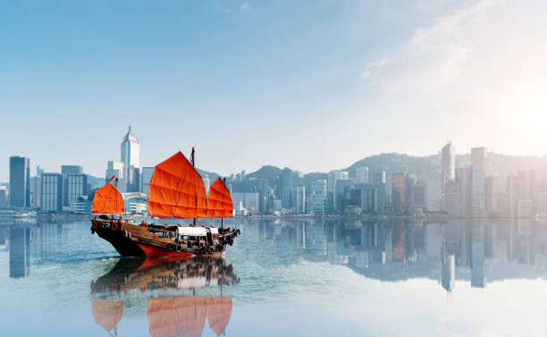 Red junk boat crossing Hong Kong harbor