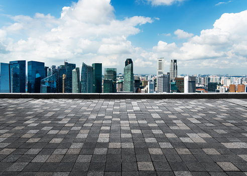 Empty brick floor against Singapore skyline