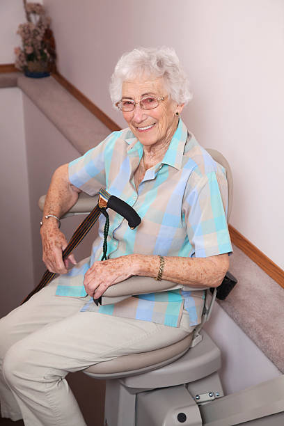 istock Elderly woman using stairlift: assisted living 155356858