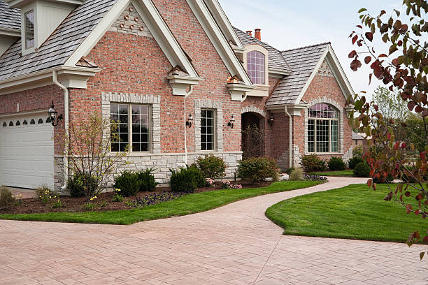 Lovely red brick upscale home with concrete driveway. stock photo