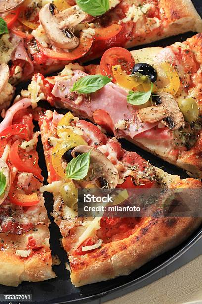 Ham Pizza Cut In Pieces Stock Photo - Download Image Now - Basil, Bell Pepper, Cheese