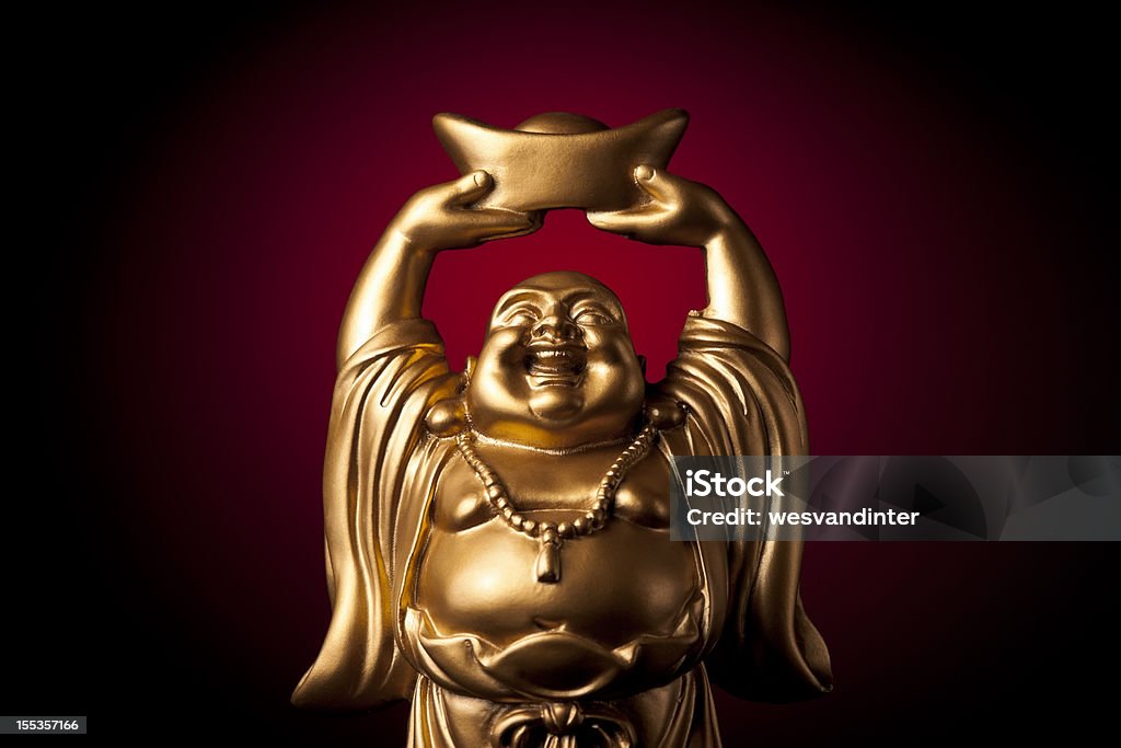 Gold Prosperity Buddha Maitreya A small, golden, carved statue of the Buddha Maitreya (also known as the Laughing Buddha).  This image said to bring fortune and prosperity to the owner. Buddha Stock Photo