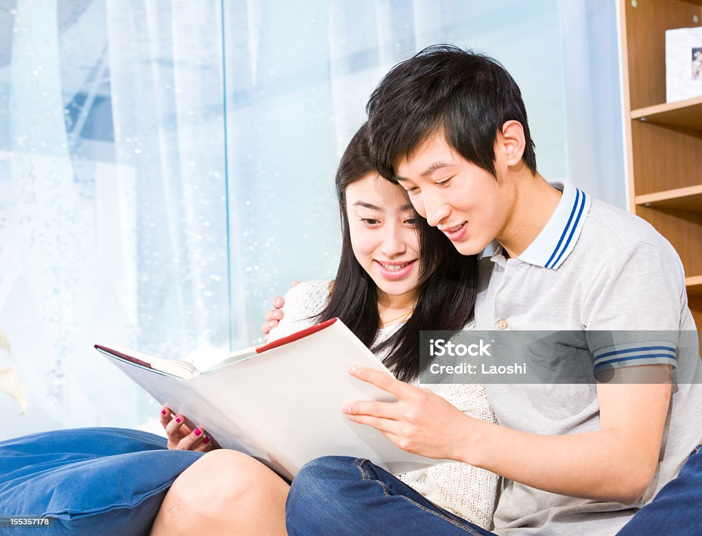 Reading a Book Young couple reading a book 20-24 Years Stock Photo