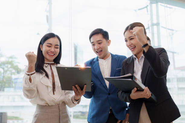 istock Diverse business team celebrate and collaboration and analyze financial data for long term investments 1553573721