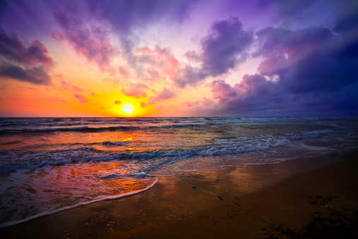 Dramatic sky reflection on a tropical beach at sunrise