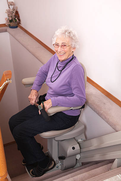 istock Elderly woman using stairlift: assisted living 155358217