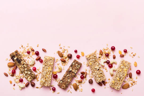 istock Various granola bars on table background. Cereal granola bars. Superfood breakfast bars with oats, nuts and berries, close up. Superfood concept 1553584049