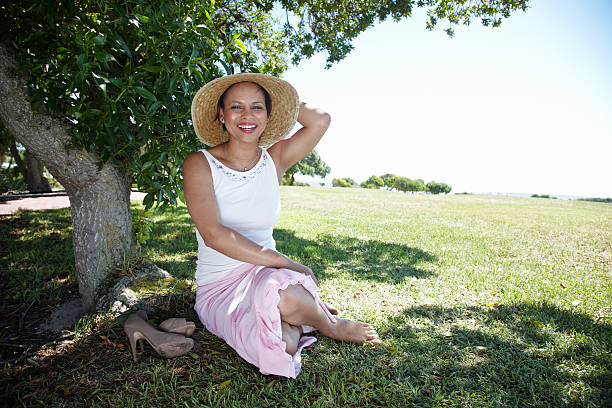 Attractive african woman under shady tree