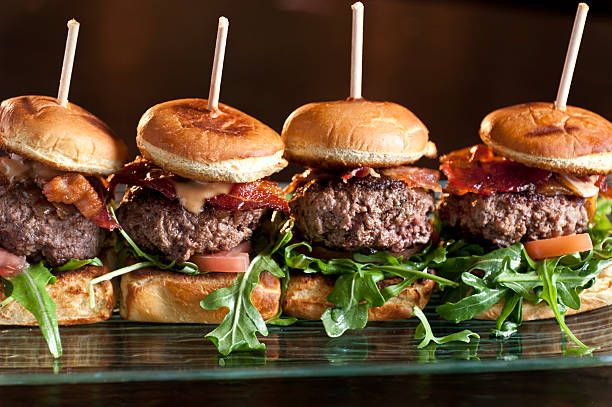 Mini Burgers Mini kobe beef burgers on black background wagyu beef stock pictures, royalty-free photos & images