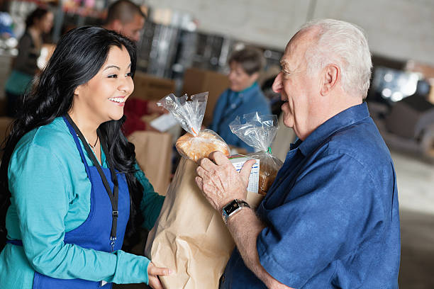 istock Senior man receiving food from volunteer 155358957