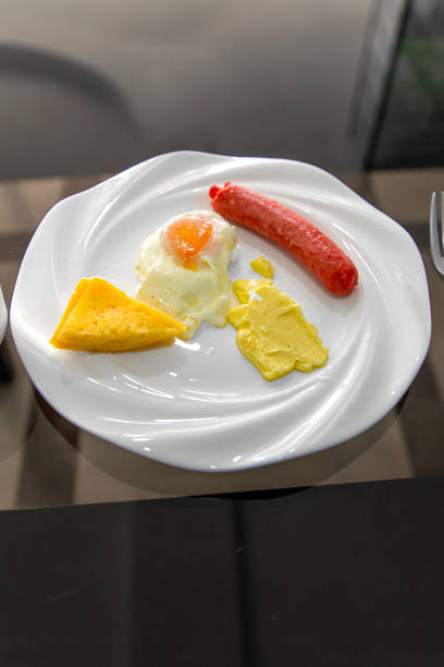 istock Delicious appetizing tomorrow - scrambled eggs with butter, cheese and sausage 1553593244