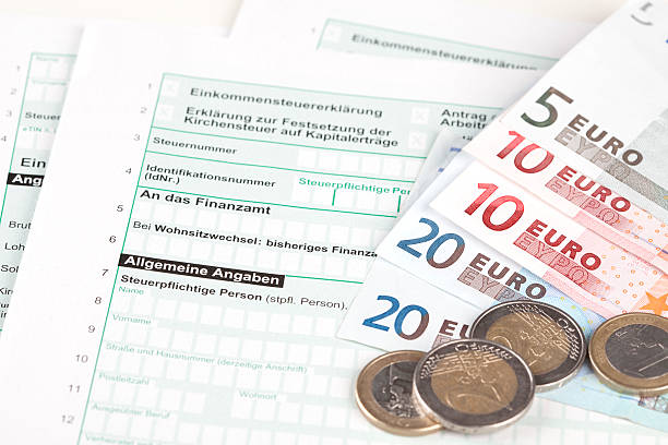 istock German Tax Form with Euro banknotes and coins 155359409