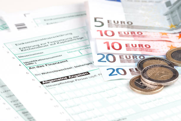 istock German Tax Form with Euro banknotes and coins 155359411