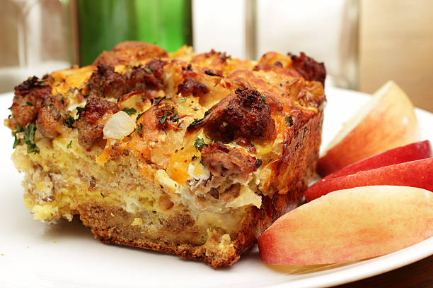 Savory Breakfast casserole A bread pudding casserole made from French baguette bread, sage breakfast sausage, onions and cheddar cheese casserole stock pictures, royalty-free photos & images