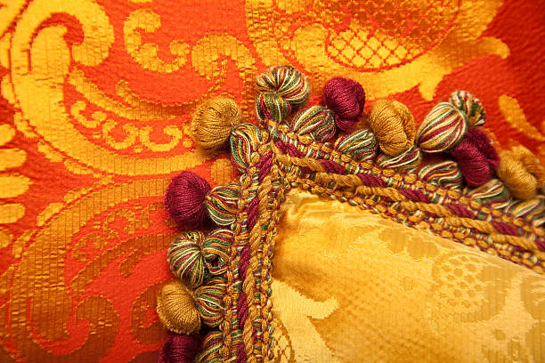 Luxurious antique style red and gold pillows with beautiful braids and tassels.