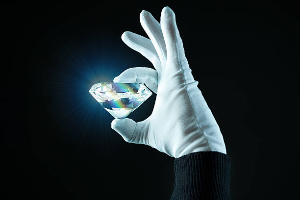 Hand wit a diamond hand holding a diamond stone object photos stock pictures, royalty-free photos & images