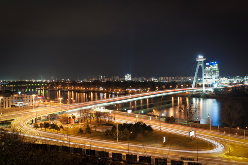Night photograph of Slovakia's Capital City, Bratislava, with traffic on the city's Novy Most bridge crossing the River Danube.