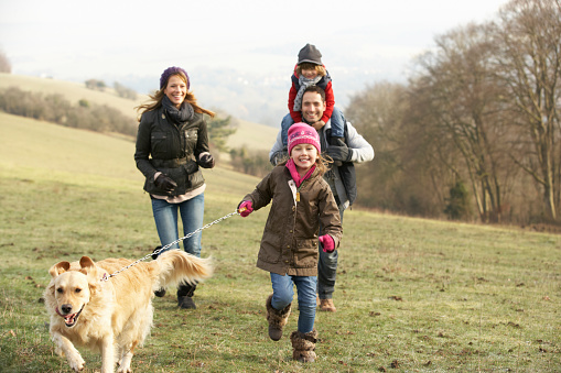 Family and dog on country walk in winter