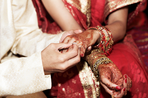 Traditional Bengali wedding in india west bengal, Bride Hand on groom hand. Selective focus on hands.